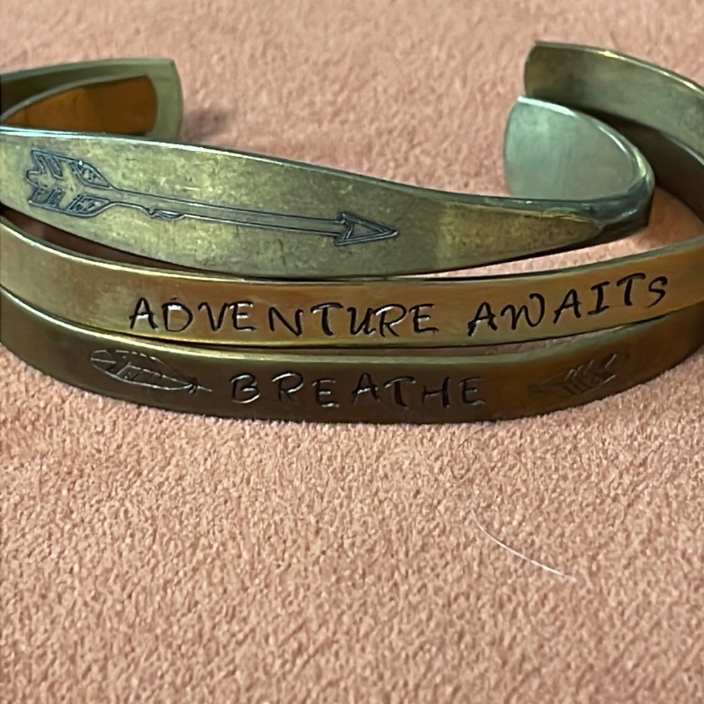 Set of 3 distressed gold bracelets.